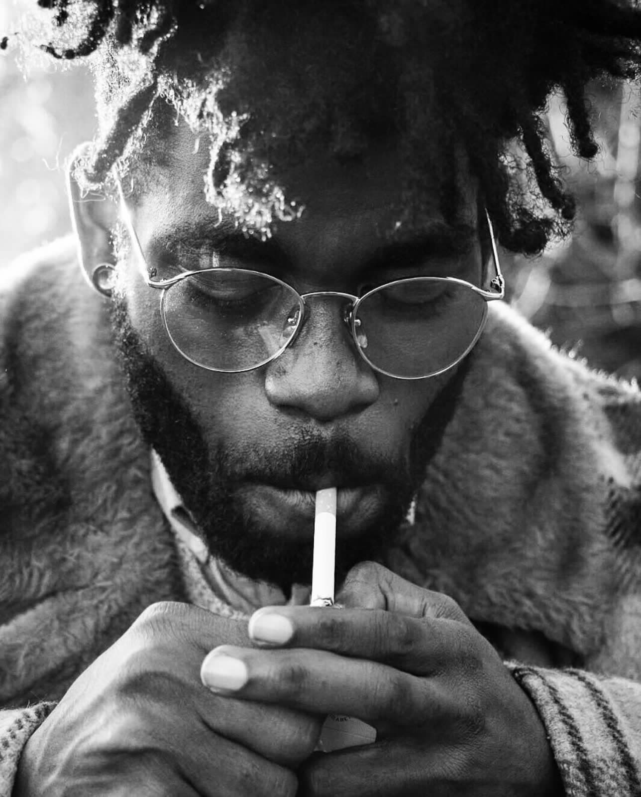 Black-and-white portrait, glasses and a cigarette, shot close