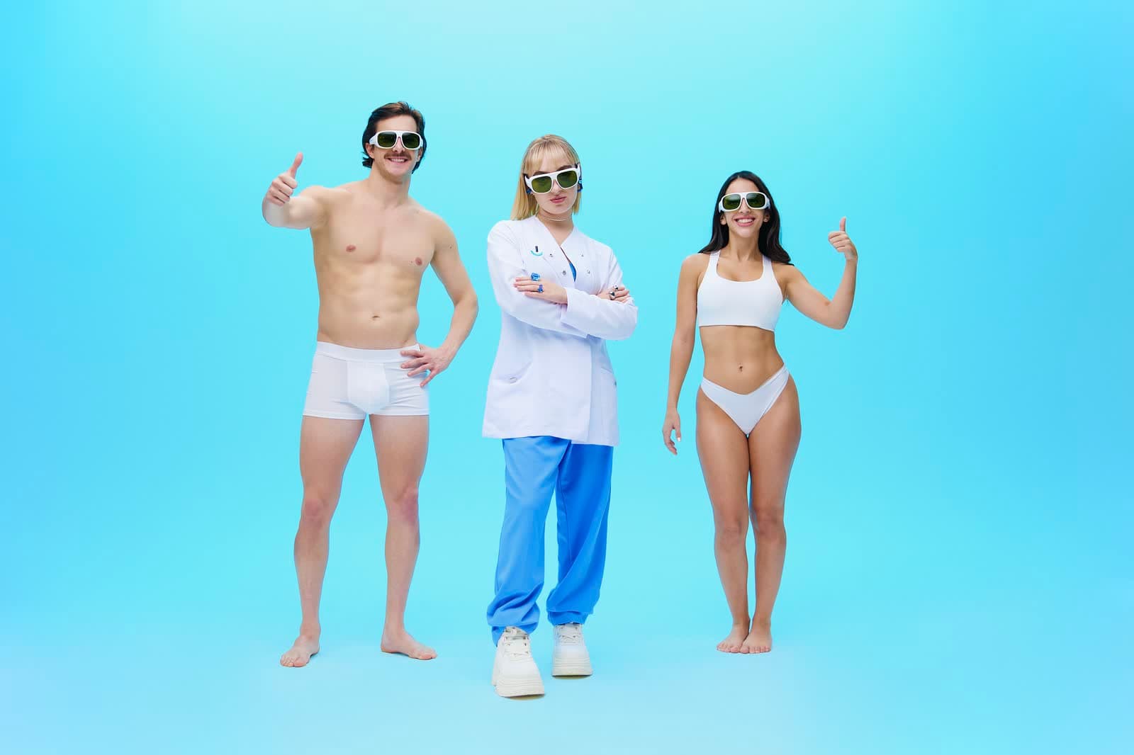 Three people posing on a blue cyclorama for a campaign